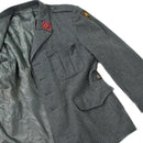 Grey Swiss military surplus wool jacket with chest pockets and emblem patches, classic formal design, warm and durable