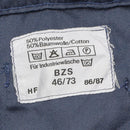 Close-up of care label on blue Swiss Civil Defense trousers showing fabric blend and washing instructions.