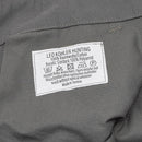 Close-up of Leo Kohler work pants label showing cotton fabric and Cordura reinforcement details