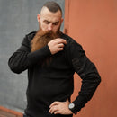 Man wearing black British army police V-neck Commando jumper with reinforced elbows and shoulders