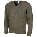 Olive drab Czech army wool sweater with V-neck, reinforced elbows, shoulder patches, and Czech flag on arm.