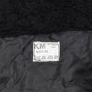 Label inside black faux fur hooded Dutch military winter coverall showing size medium and care instructions