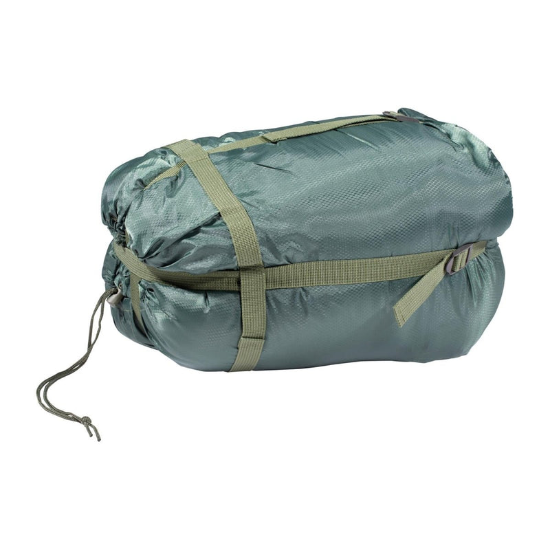 Compact green water-resistant sleeping bag packed tight with adjustable straps for summer camping and bushcrafting.