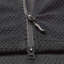 Close-up of black textured fleece fabric with sturdy metal zipper on military style thermal jacket