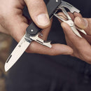 Hand holding Fox Knives VULPIS multi tool with N690Co steel blade, scissors, bottle opener, and screwdriver extended