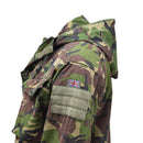 Side view of genuine British Army SAS combat smock with DPM camo, hood, and Union Jack patch on sleeve