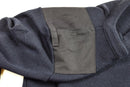 Close-up of a dark blue genuine Dutch army sweater showing reinforced shoulder patch and knit fabric texture.