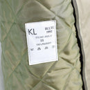 Close-up of quilted polyester lining with care label inside Genuine Dutch Army Women's khaki trench coat from 1992.