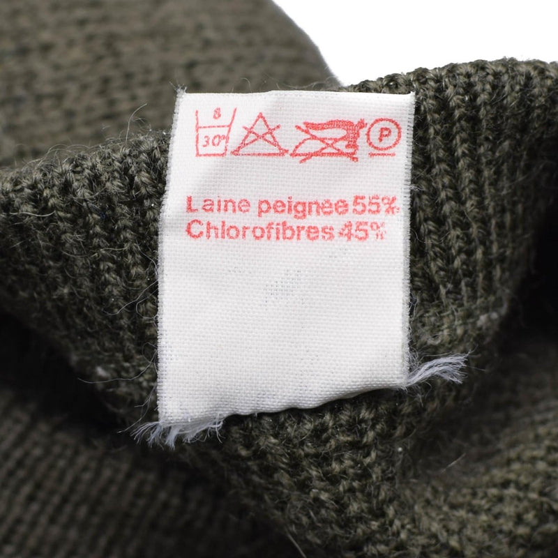 Care label on olive green French army pullover showing wool and chlorofibres blend composition and care symbols