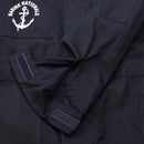 Close-up of dark blue French navy coverall sleeve with adjustable Velcro cuff and Marine Nationale anchor emblem embroidery