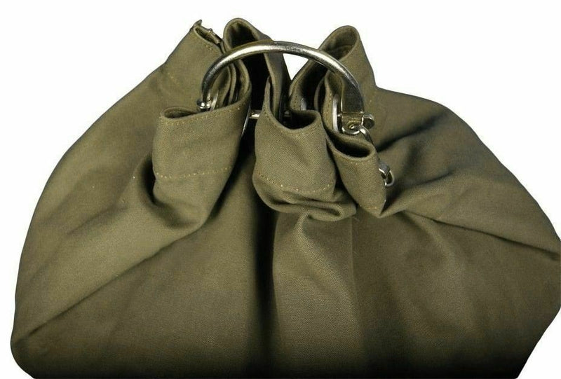 Close-up of olive green Genuine German Army sea sack duffel bag with metal ring hanger and durable fabric folding detail.