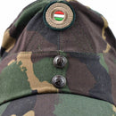 Close-up of Hungarian camo army winter cap with color badge and metal buttons on front panel