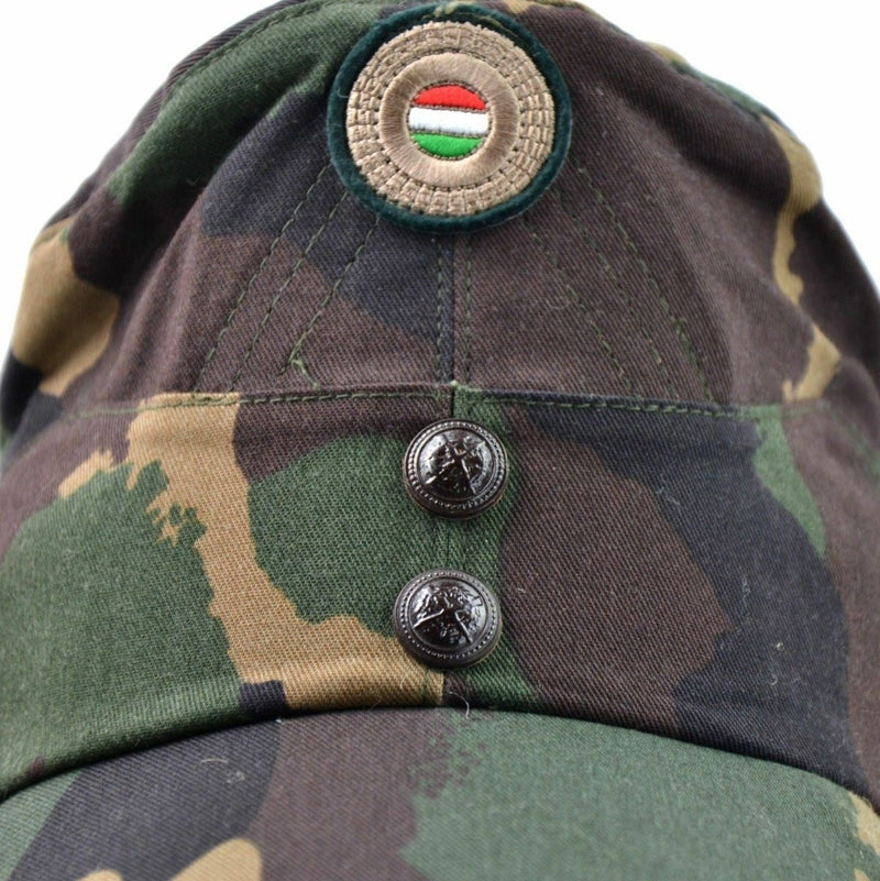Close-up of Hungarian camo army winter cap with color badge and metal buttons on front panel