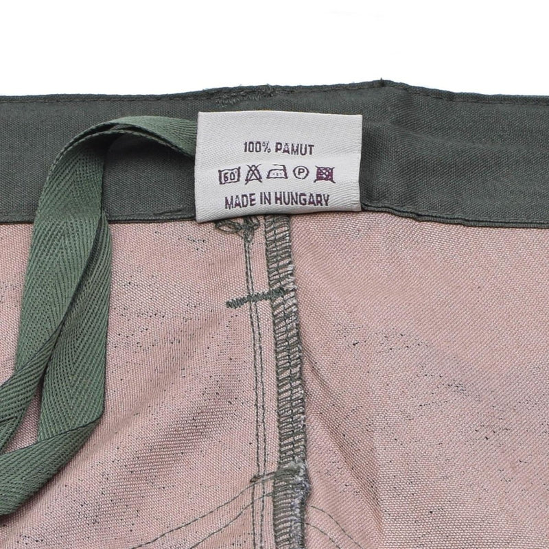 Close-up of the inside label on Hungarian military M1990 field pants showing 100% cotton and made in Hungary.