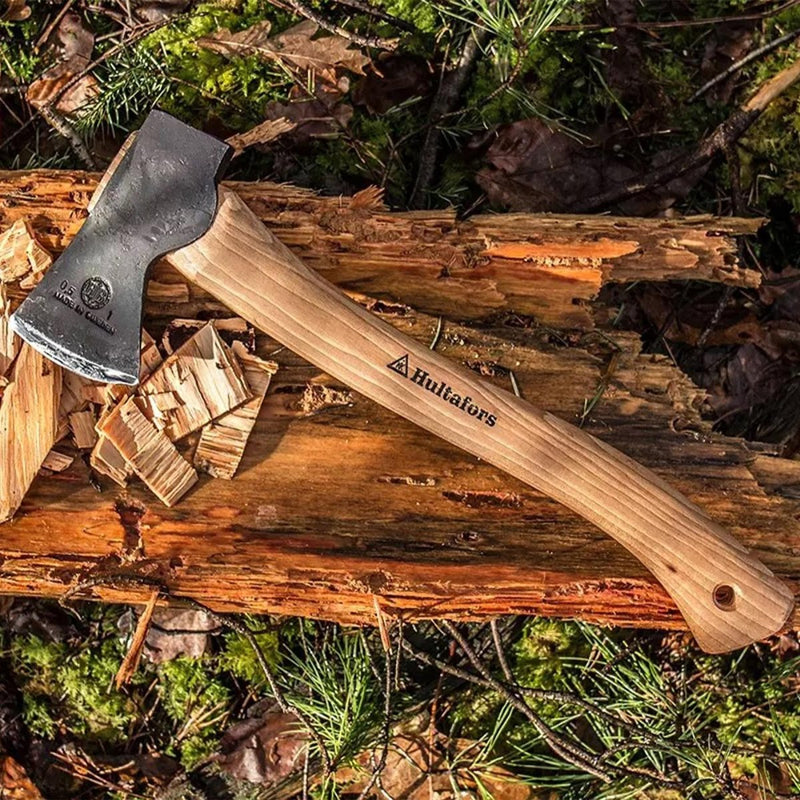 Hultafors Hultan gardening axe with carbon steel blade and hickory handle resting on chopped wood outdoors