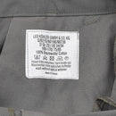 Care label on Leo Kohler gray cotton military cargo trousers with washing and care instructions shown