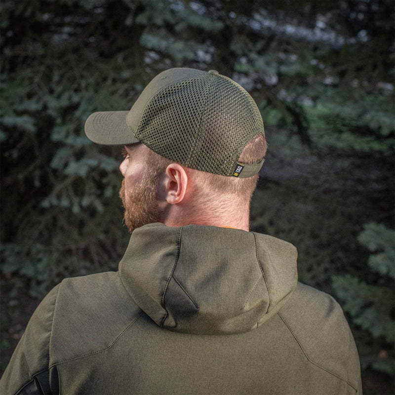 Man wearing olive M-TAC military style baseball cap with mesh back and adjustable strap outdoors