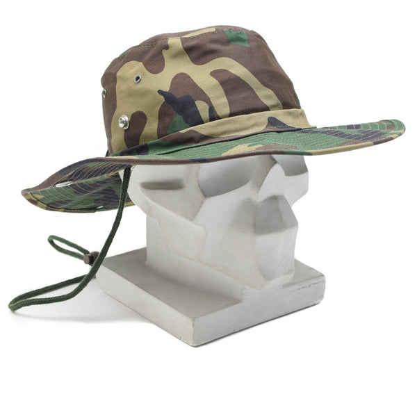 Woodland camouflage military boonie hat with wide brim and adjustable chin strap for outdoor protection and comfort.