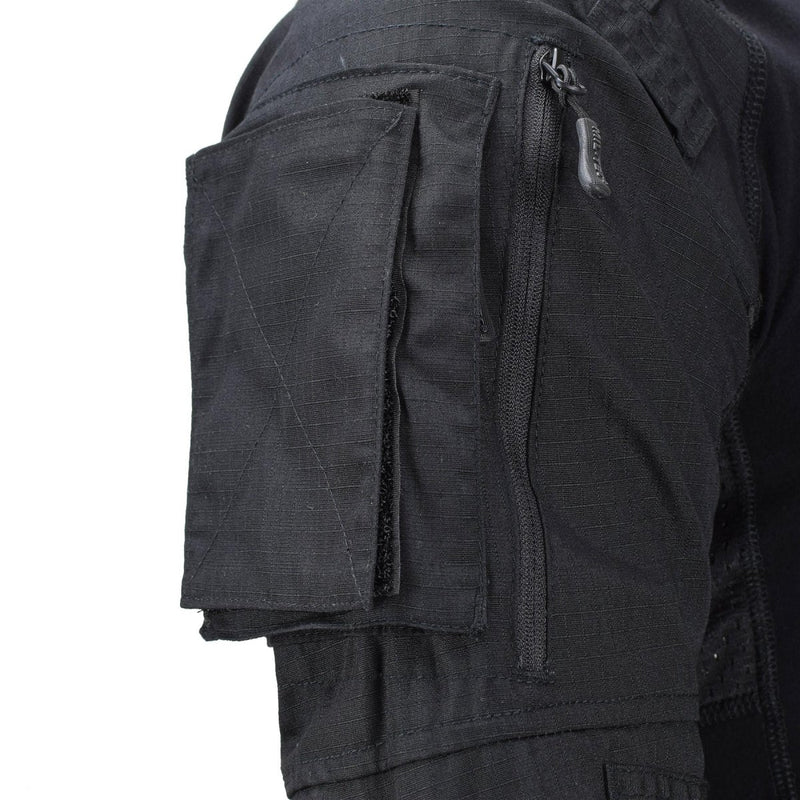 Close-up of black tactical combat shirt sleeve showing zippered pocket and padded elbow pocket by Mil-Tec