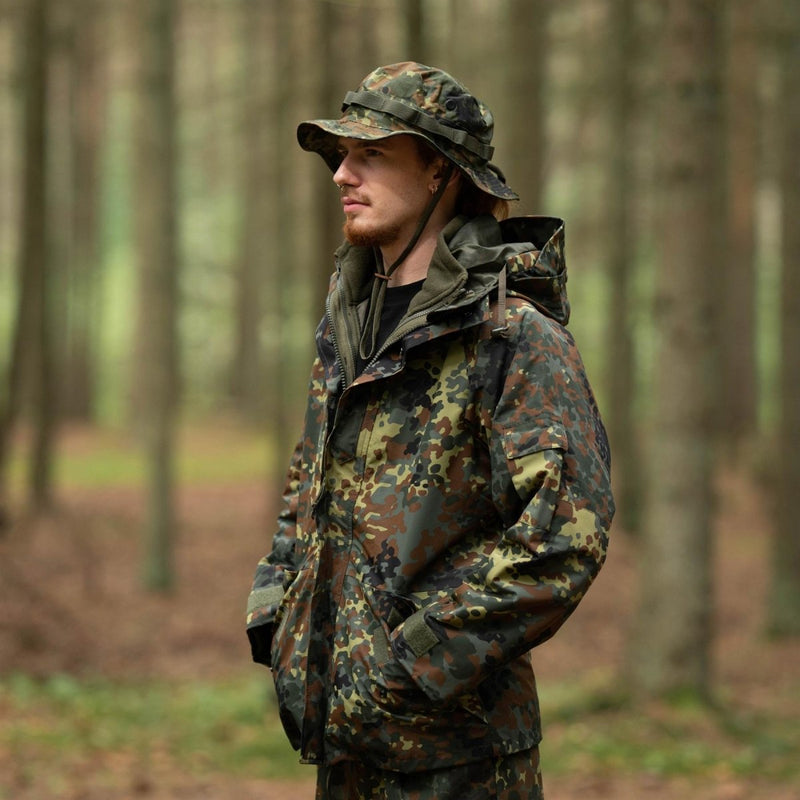 Man wearing Mil-Tec military style ripstop boonie hat and camouflage jacket in a forest setting
