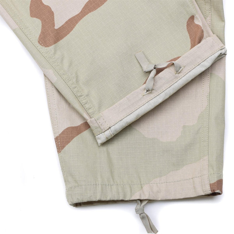 Close-up of Mil-Tec U.S. Army style cargo pants in 3-color desert camouflage ripstop fabric with adjustable ankle ties