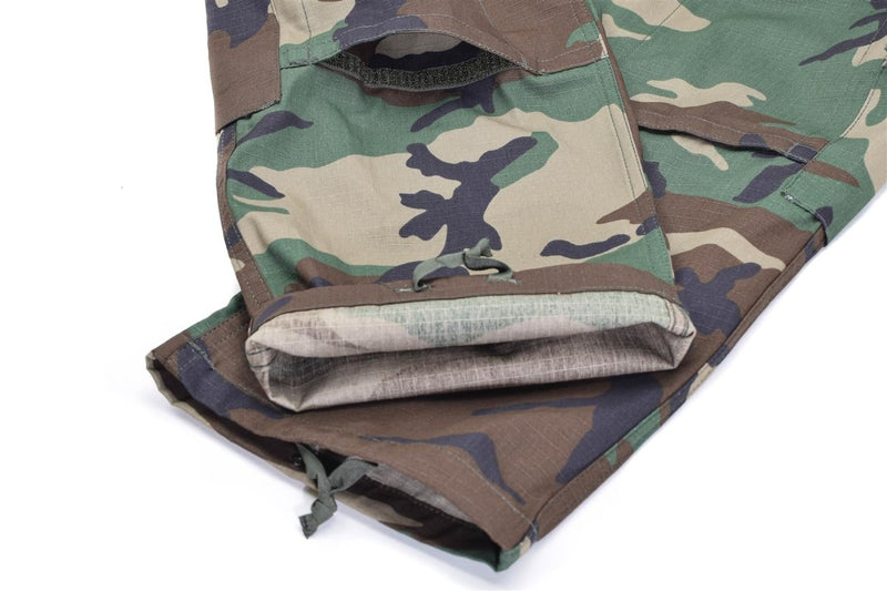 Close-up of Mil-Tec U.S. Military-style woodland camo ripstop BDU cargo pants with adjustable cuffs and reinforced fabric