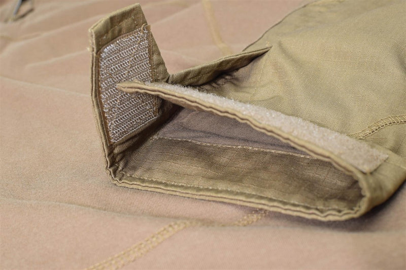 Close-up of dark coyote Mil-Tec military style tactical combat shirt sleeve with hook and loop fastener detail.