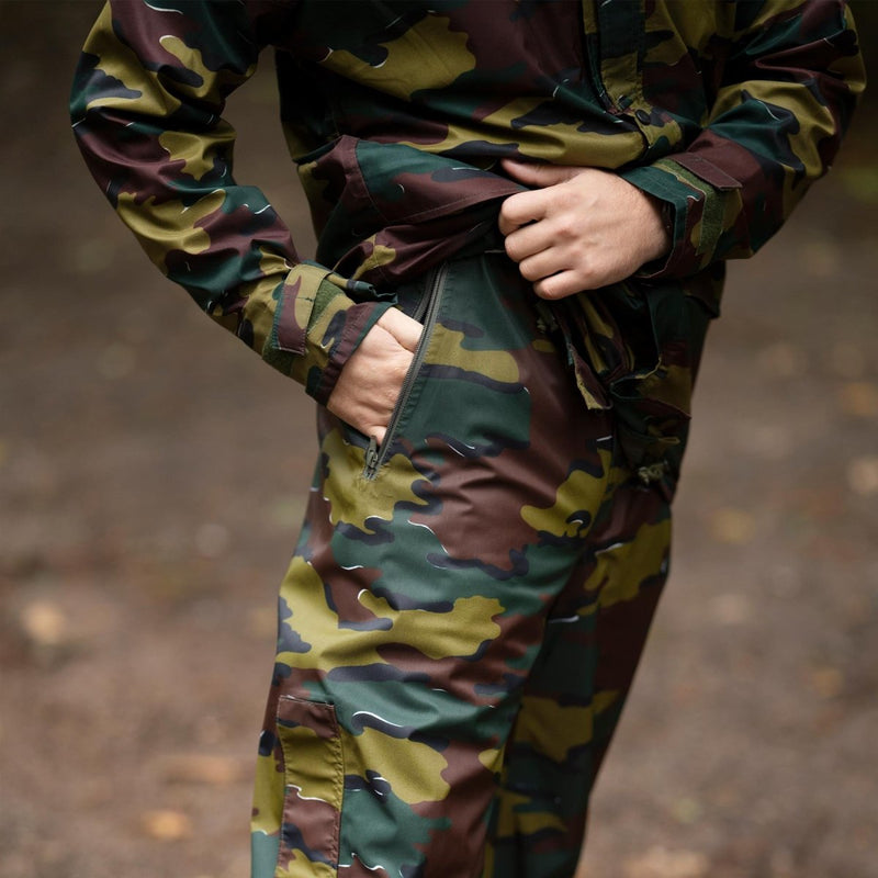 Close-up of original Belgian military waterproof jigsaw camo rain trousers with hand in pocket outdoors