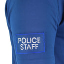Close-up of blue breathable police staff t-shirt sleeve with embroidered patch on lightweight fabric
