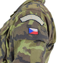 Close-up of Czech Republic military field jacket showing leaf camo pattern and national flag patch on sleeve pocket
