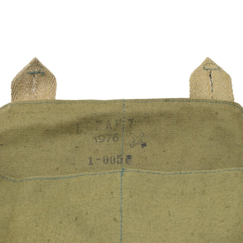 Close-up of vintage green canvas Czech military gas mask shoulder bag with faded stamped markings and stitched loops.