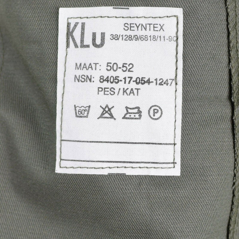Close-up of laundry care label on Original Dutch Army M65 Air Force shirt jacket showing size and washing instructions.