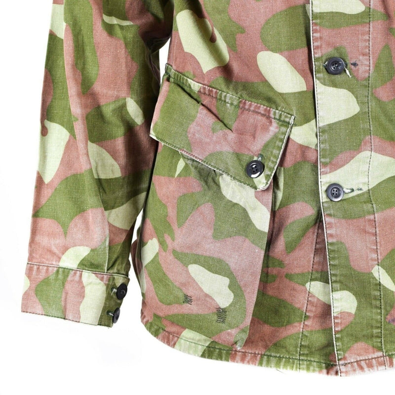 Close-up of Finnish M-62 army camo jacket sleeve and front pocket in green and brown reversible design