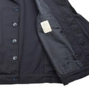 Close-up of original French military alpine troops blue cotton jacket showing buttoned front and inner lining with label.