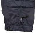 Close-up of durable blue fabric sleeve with zipper and adjustable Velcro strap on police coverall jumpsuit