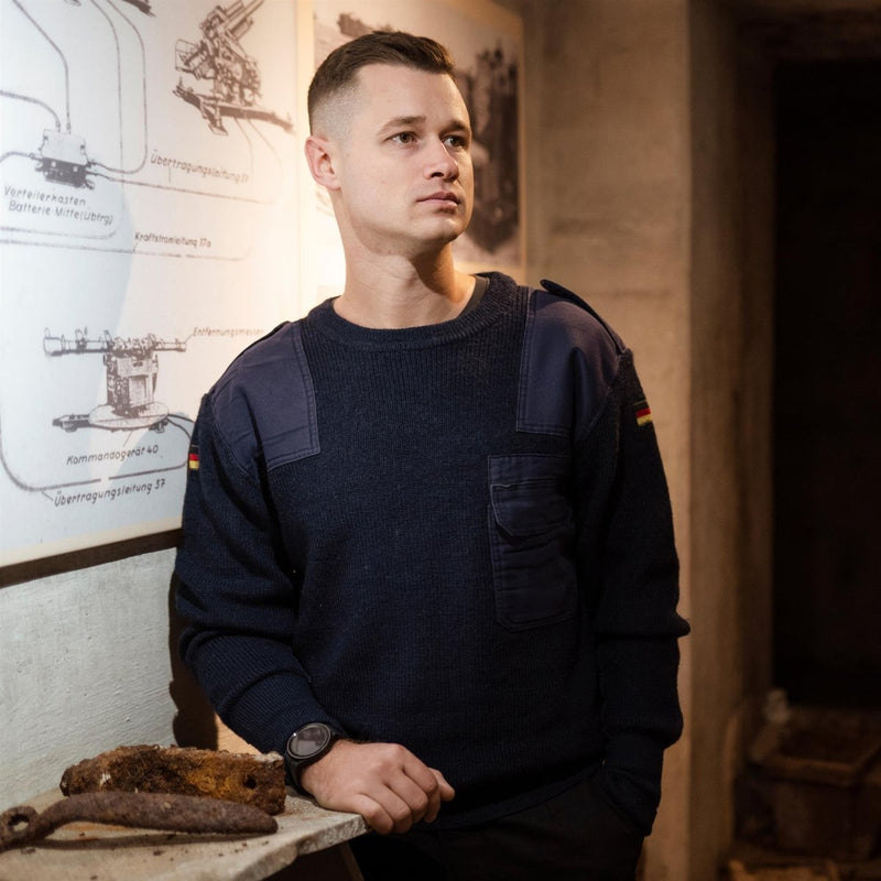 Man wearing original German army navy blue commando jumper sweater with reinforced shoulders and German flag patch