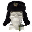 Original German police black faux fur ushanka with ear flaps and badge displayed on white mannequin head