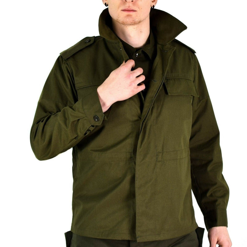 Man wearing an original vintage Czech M85 olive green military field jacket with buttoned cuffs and epaulets