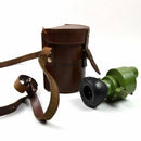 Original Yugoslavian army ON-M59 monocular with rubber eye cup and brown leather carrying case on white background.