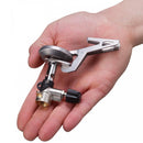 Hand holding compact, lightweight foldable Primus Express hiking stove for outdoor camping use