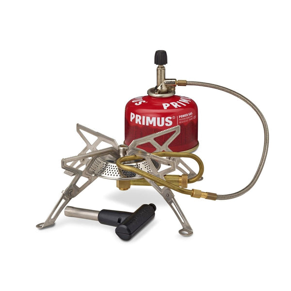 Primus Gravity III high output camping burner with foldable legs, gas canister, and ignition tool for outdoor cooking.