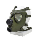 Vintage Romanian M74 full face olive green gas mask with adjustable straps and dual circular eyepieces displayed on mannequin head